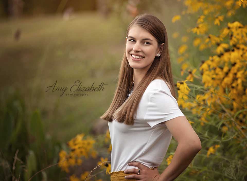 college girl standing among flowers st louis family photographers