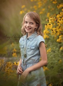 girl in blue among yellow flowers st louis family photographers