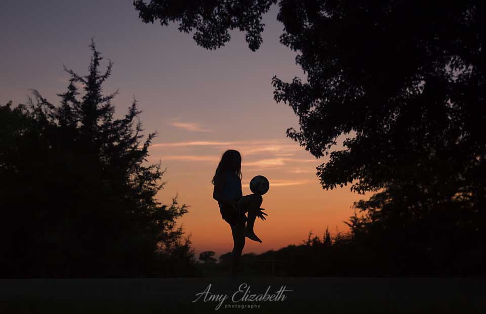 preteen girl with soccer ball summer silhouette