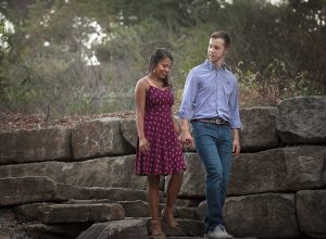 engaged couple walking down stone steps