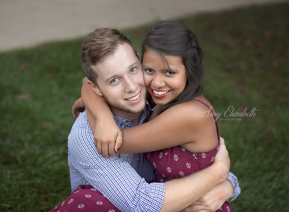 engaged couple hugging with big smiles