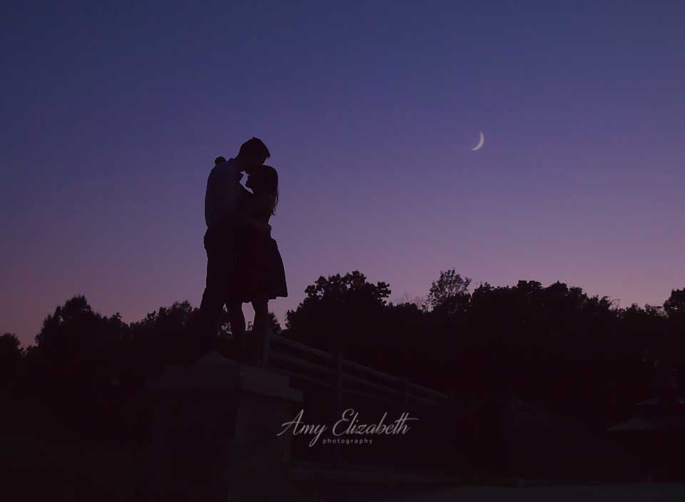 silhouette of engaged couple with moon