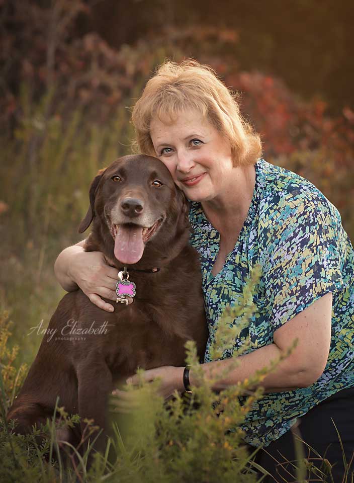 portrait of owner with chocolate lab dog during fall session