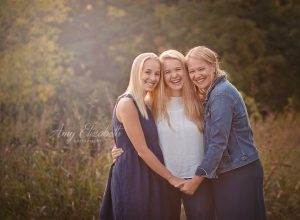mom and two sisters laughing