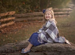 little girl wrapped in blanket for family pictures