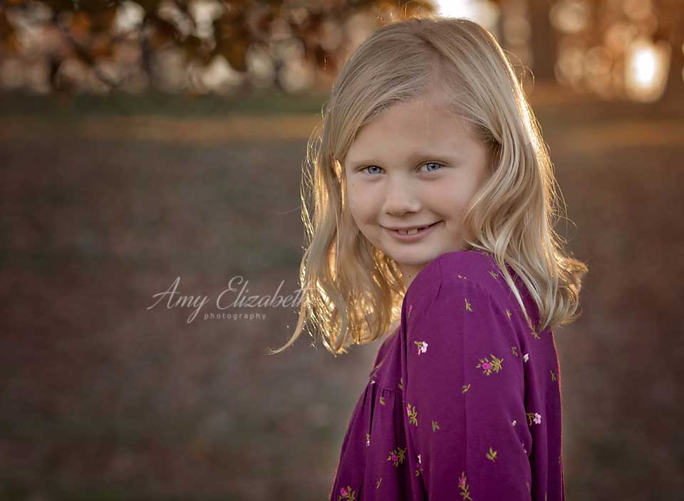 blonde little girl in purple dress