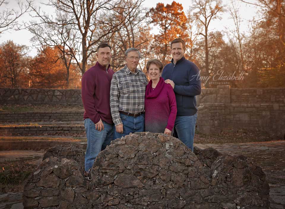 family with two grown sons on rock bridge