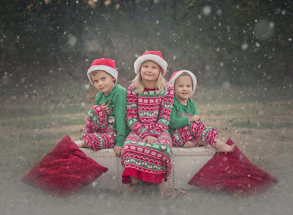 three siblings in Christmas pajamas