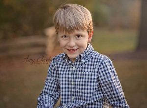 little boy in gingham shirt for fall family pictures