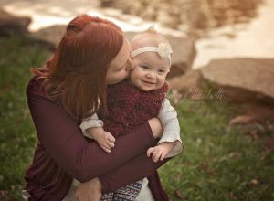 mom kissing baby girl st louis photographer