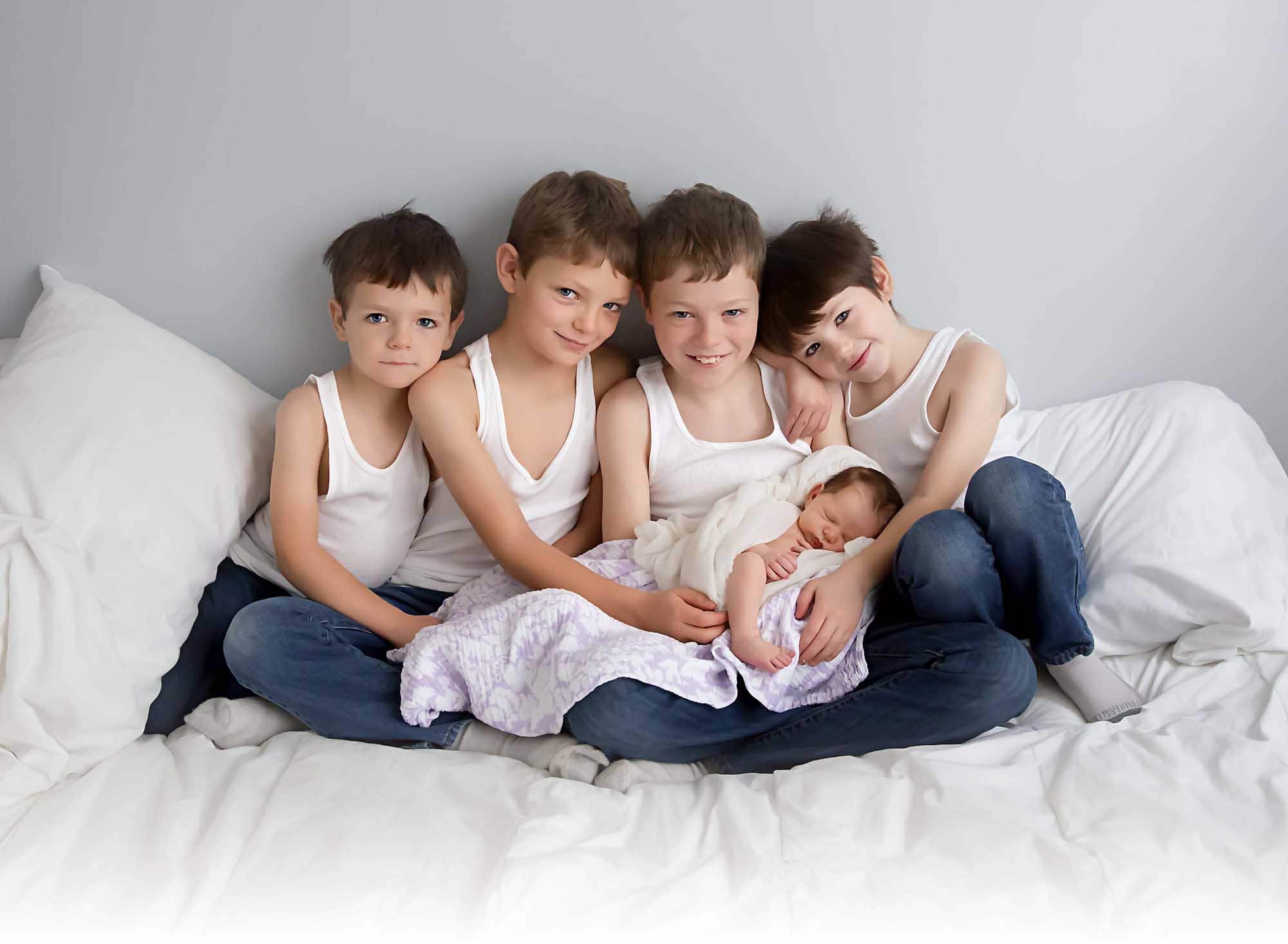 four brother holding new sister st louis newborn photographer
