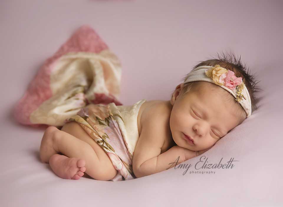 newborn girl in vintage pink st louis newborn photographer