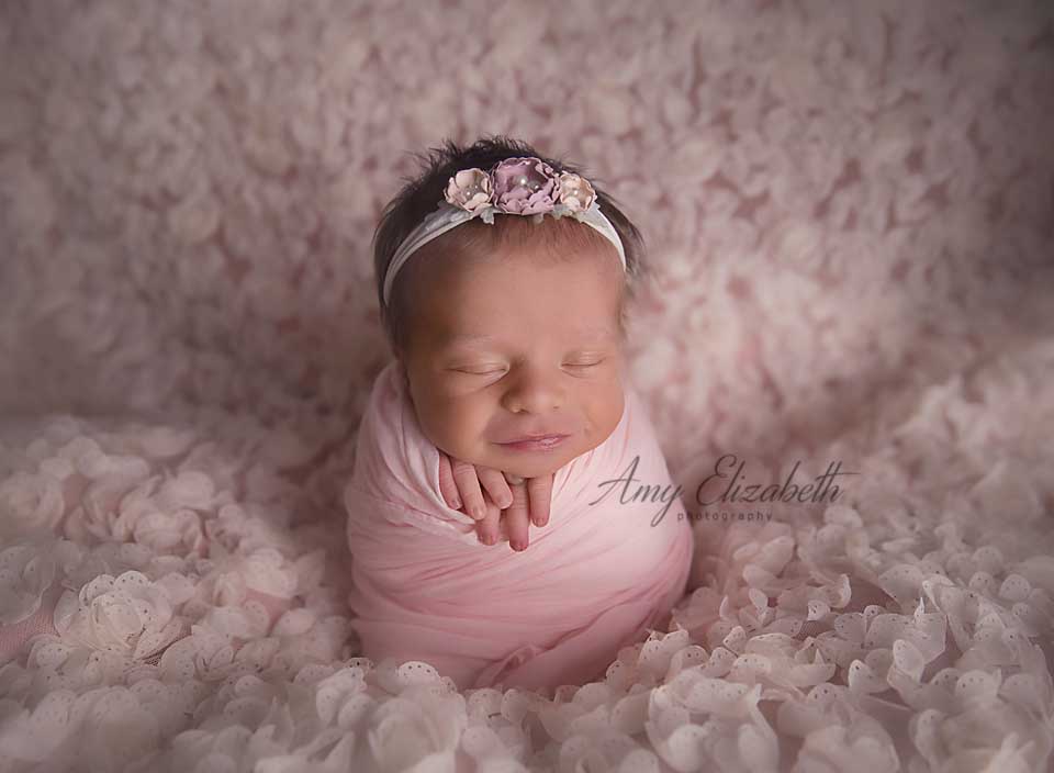 potato sack pose in pink st louis newborn