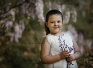 little girl among purple flowers st louis photographer