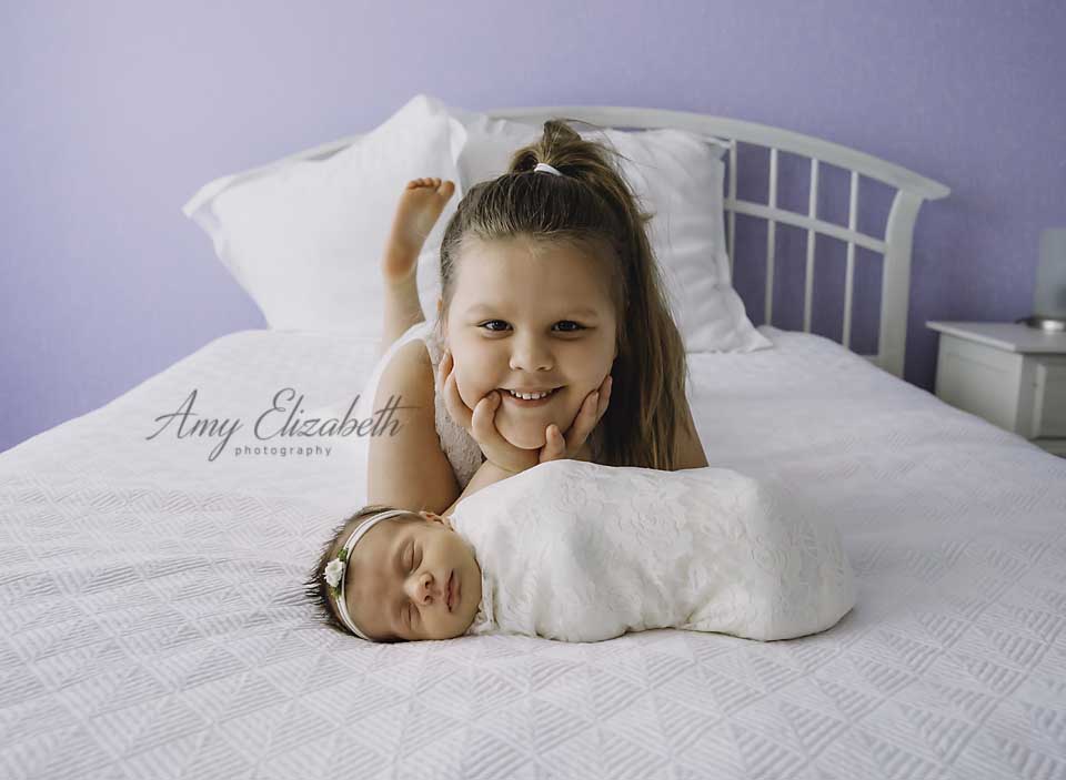 big sister with new baby st louis lifestyle newborn photographer