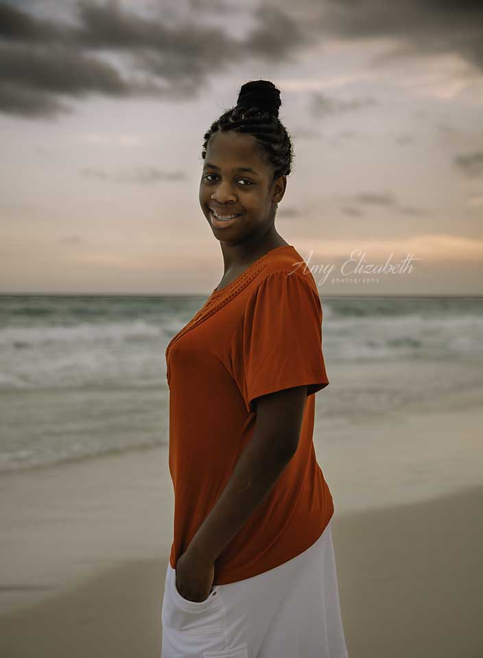 girl in orange shirt on beach st louis family photographer